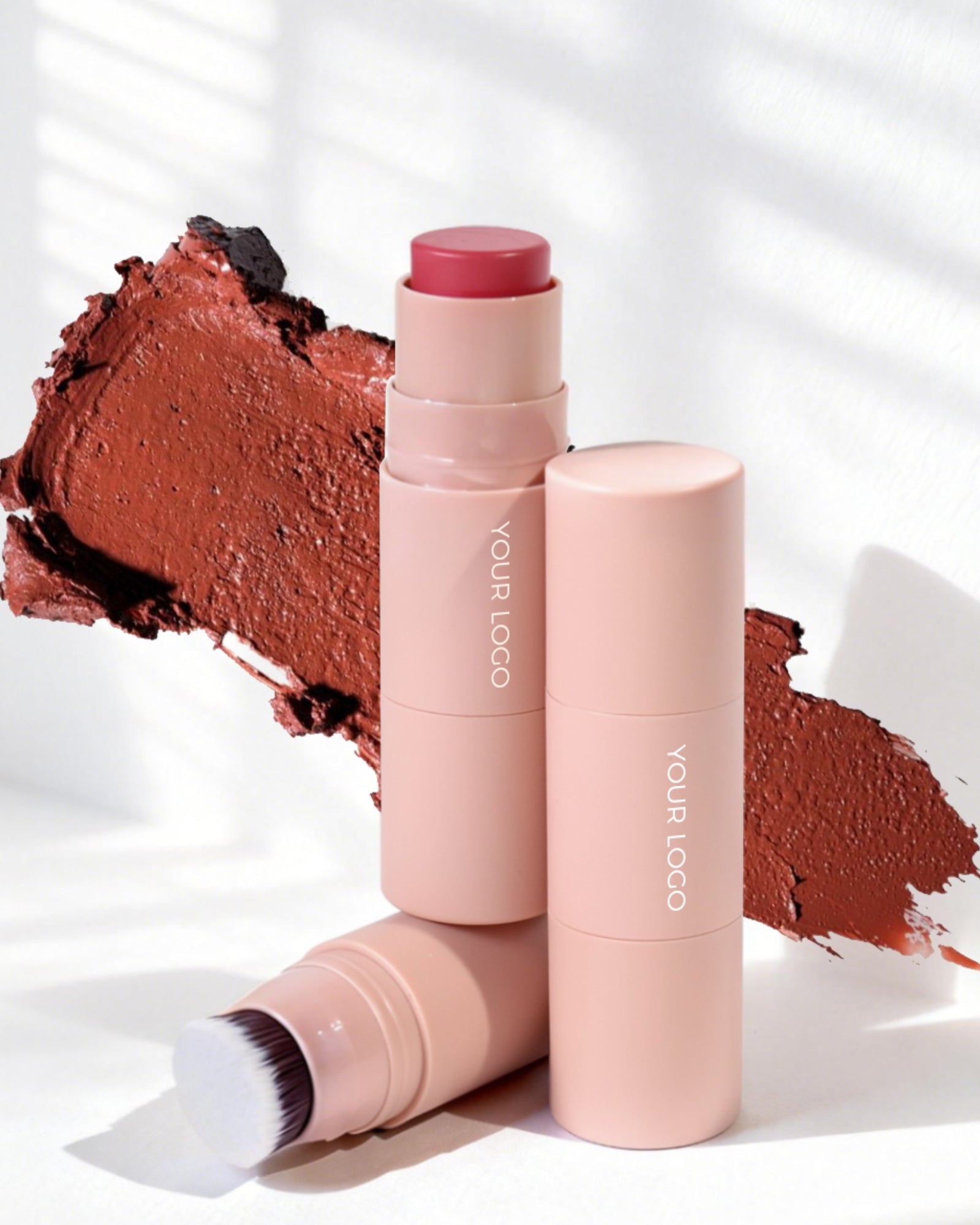 Makeup stick with applicator and logo on a white background